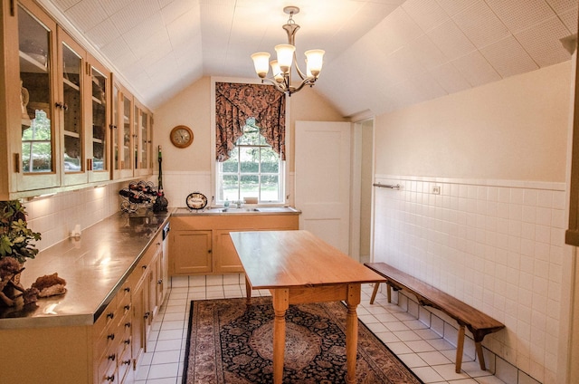 kitchen featuring sink, a chandelier, vaulted ceiling, light brown cabinetry, and light tile patterned flooring