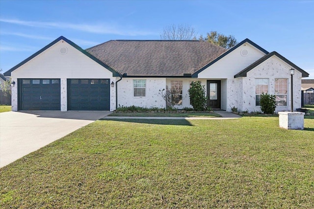 view of front of property with a garage and a front lawn