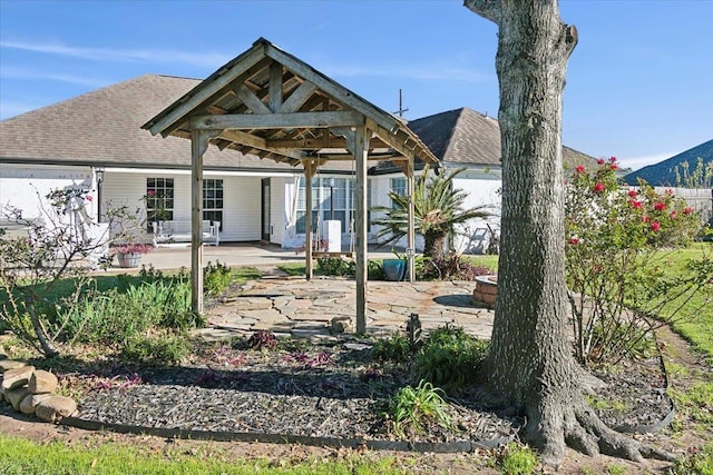 back of house with a gazebo and a patio