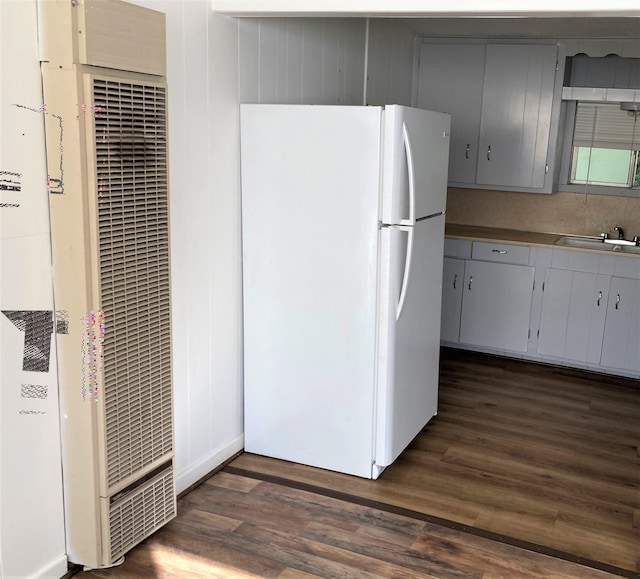 4701 Redbird St, Port Arthur, TX 77642 - kitchen with freestanding refrigerator, a heating unit, a sink, and dark wood-type flooring