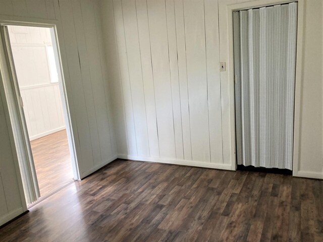 4701 Redbird St, Port Arthur, TX 77642 - unfurnished bedroom with dark wood-style floors and baseboards