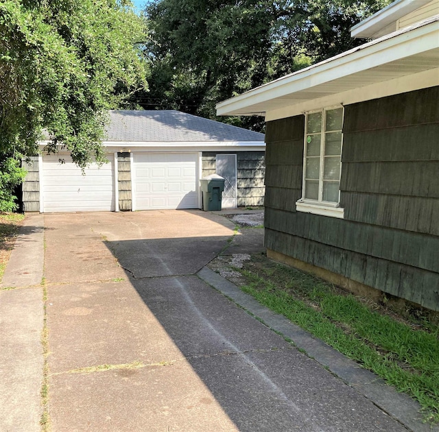 4701 Redbird St, Port Arthur, TX 77642 - view of side of property featuring an outdoor structure, a garage, and driveway
