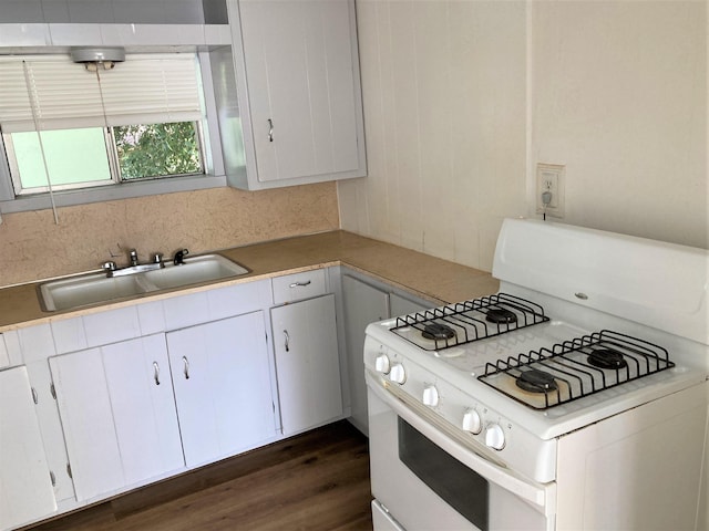 4701 Redbird St, Port Arthur, TX 77642 - kitchen featuring white gas range, a sink, decorative backsplash, light countertops, and white cabinets