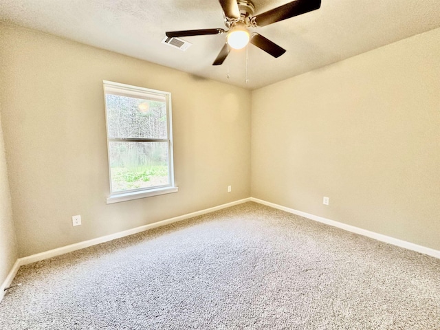 empty room featuring ceiling fan and carpet floors