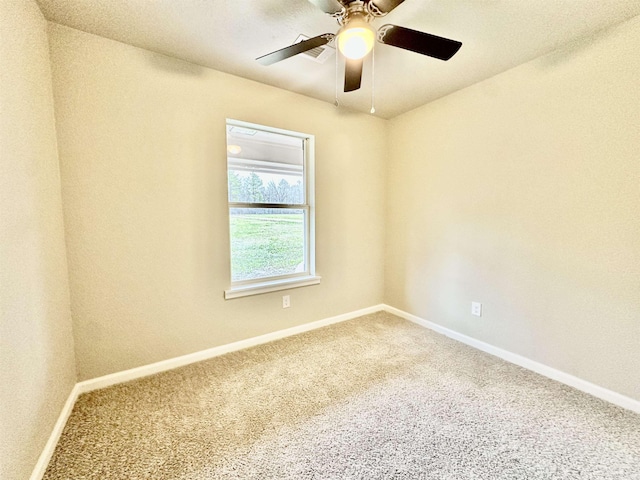 unfurnished room with ceiling fan and carpet