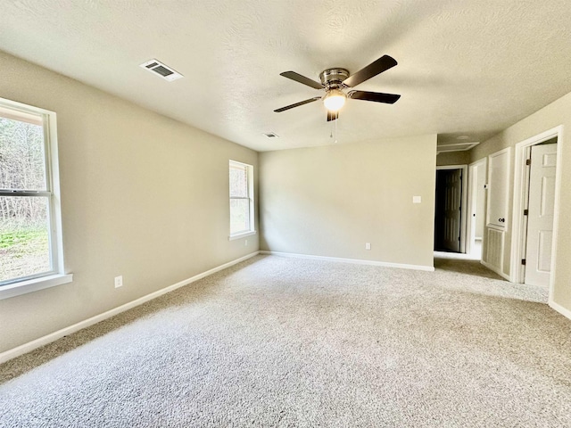 unfurnished room with light carpet, a textured ceiling, and ceiling fan