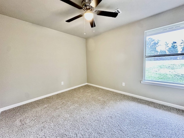 carpeted spare room with plenty of natural light and ceiling fan