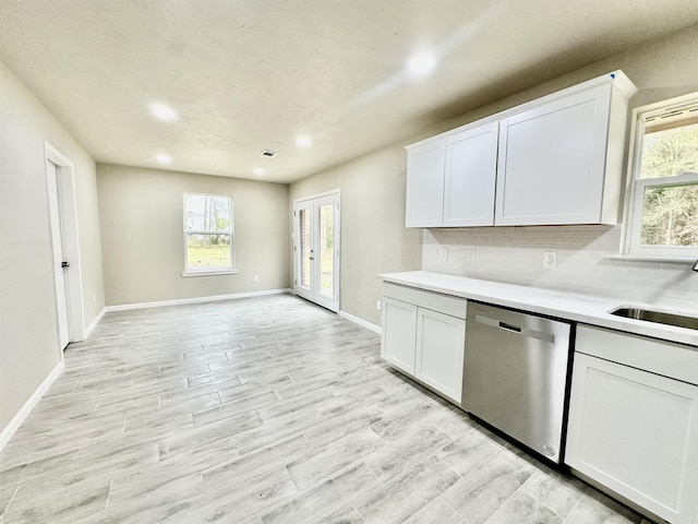 kitchen featuring white cabinets, dishwasher, and french doors