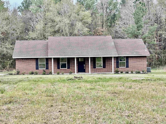 ranch-style home featuring central AC and a front lawn