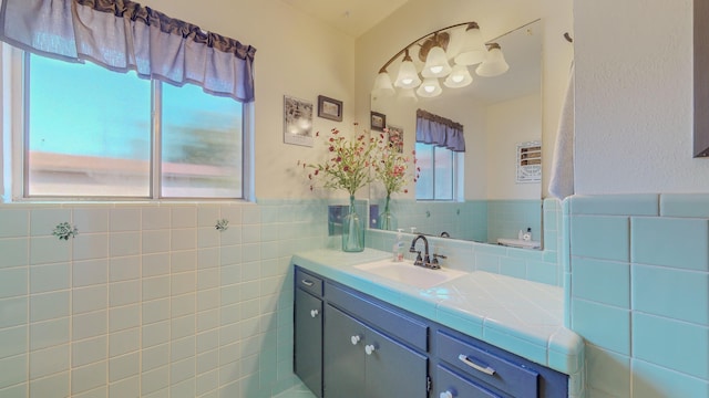 bathroom featuring a wainscoted wall, tile walls, and vanity