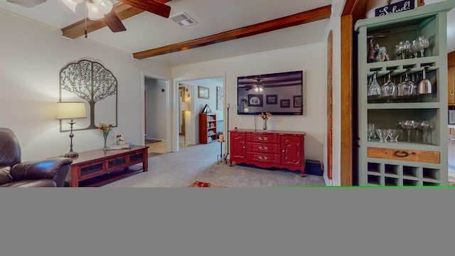 interior space featuring beam ceiling, visible vents, ceiling fan, and carpet