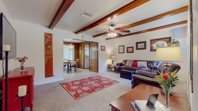 living area with visible vents, beam ceiling, carpet, and a ceiling fan