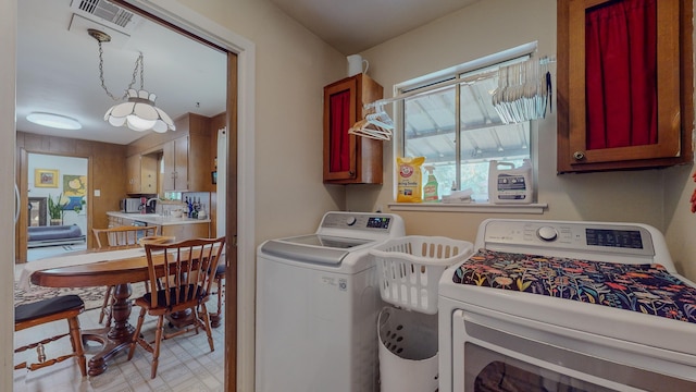 laundry room with cabinet space, visible vents, independent washer and dryer, and light floors