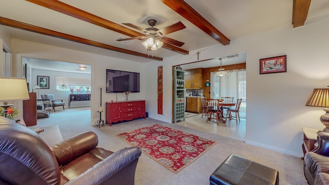 living area featuring beamed ceiling, light carpet, baseboards, and ceiling fan