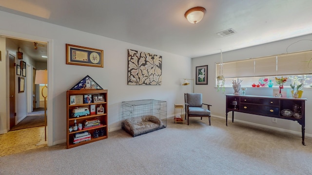 living area featuring visible vents, carpet floors, and baseboards