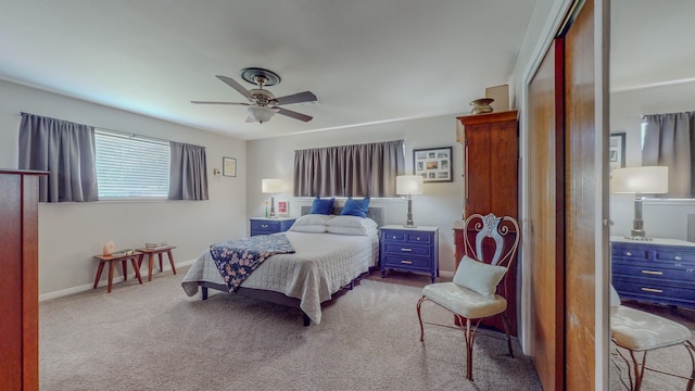 carpeted bedroom featuring a closet, baseboards, and ceiling fan