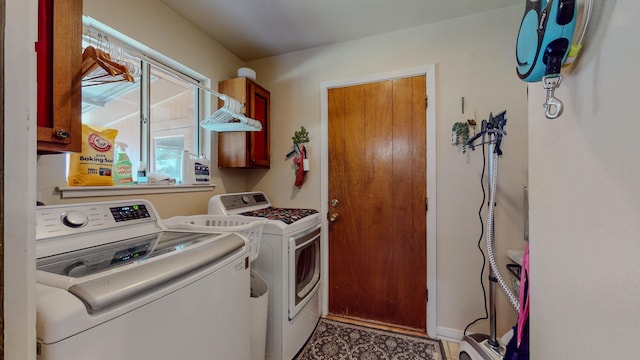 laundry room with cabinet space and washer and clothes dryer