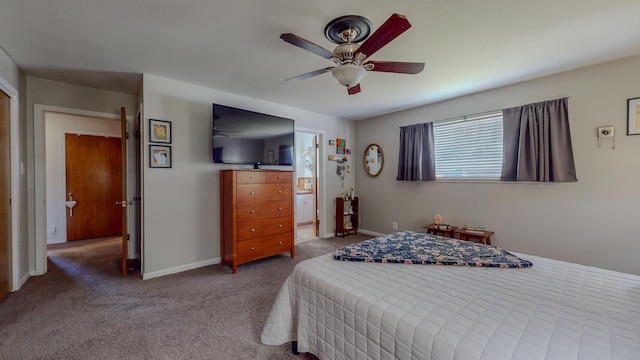 carpeted bedroom featuring connected bathroom, baseboards, and ceiling fan