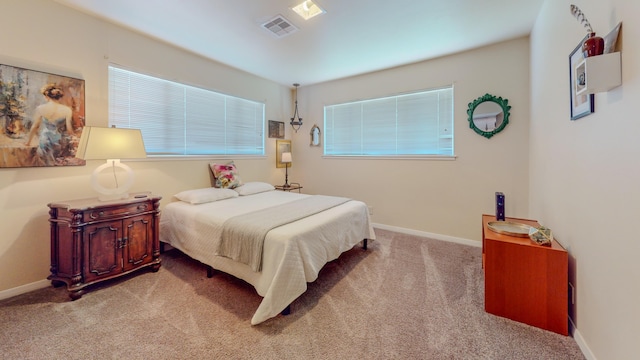 bedroom with carpet, visible vents, and baseboards