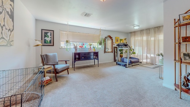 sitting room featuring a wealth of natural light, visible vents, carpet floors, and baseboards