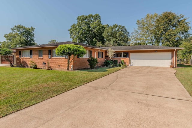 ranch-style house featuring brick siding, driveway, an attached garage, and a front lawn