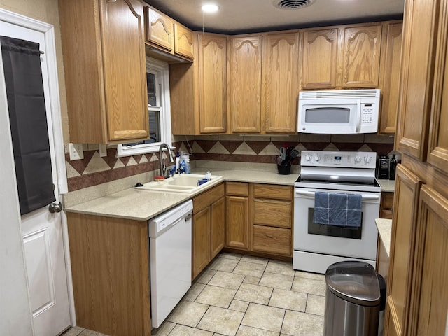 3720 Austin St, Beaumont, TX 77706 - kitchen with white appliances, a sink, decorative backsplash, and light countertops