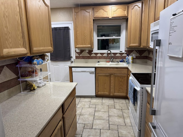 3720 Austin St, Beaumont, TX 77706 - kitchen featuring white appliances, a sink, decorative backsplash, and light countertops