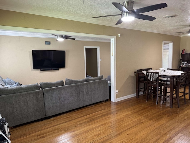 3720 Austin St, Beaumont, TX 77706 - living area with ceiling fan, a textured ceiling, wood finished floors, crown molding, and baseboards