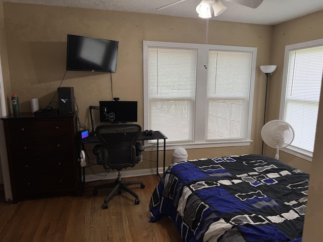 3720 Austin St, Beaumont, TX 77706 - bedroom featuring wood finished floors, an office area, a ceiling fan, and baseboards