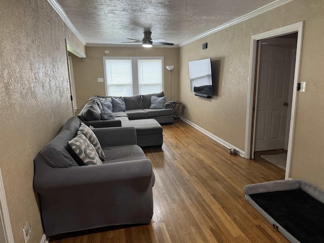 3720 Austin St, Beaumont, TX 77706 - living room featuring a textured wall, ceiling fan, wood finished floors, ornamental molding, and baseboards