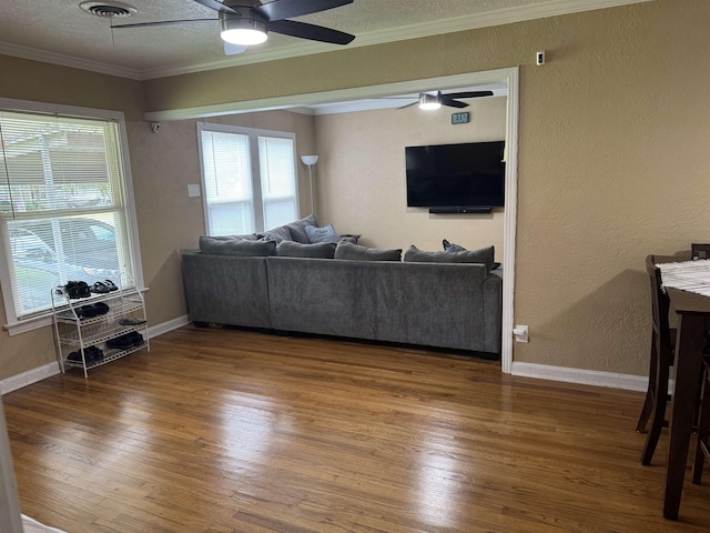3720 Austin St, Beaumont, TX 77706 - living area featuring ceiling fan, ornamental molding, wood finished floors, a textured ceiling, and baseboards