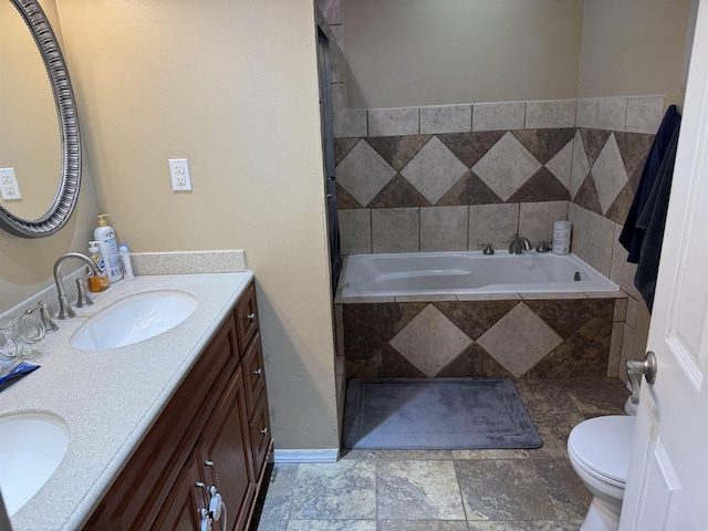 3720 Austin St, Beaumont, TX 77706 - full bath with double vanity, tiled tub, and toilet
