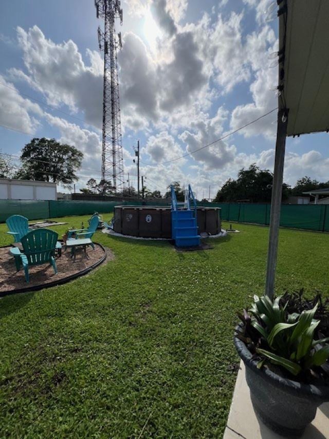 view of yard with a fenced in pool and fence