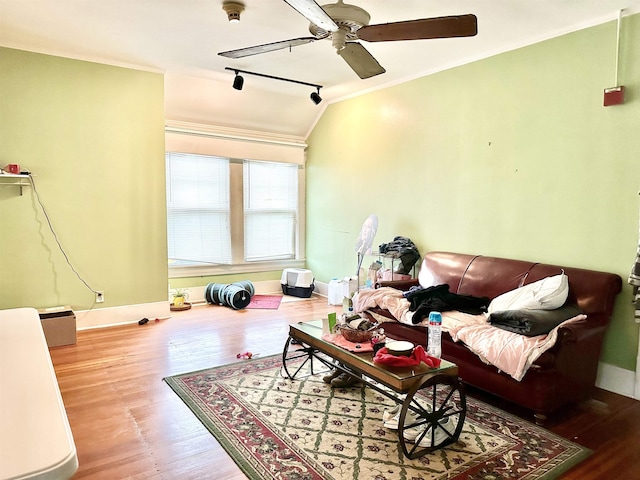 living room with hardwood / wood-style floors, lofted ceiling, ceiling fan, and ornamental molding