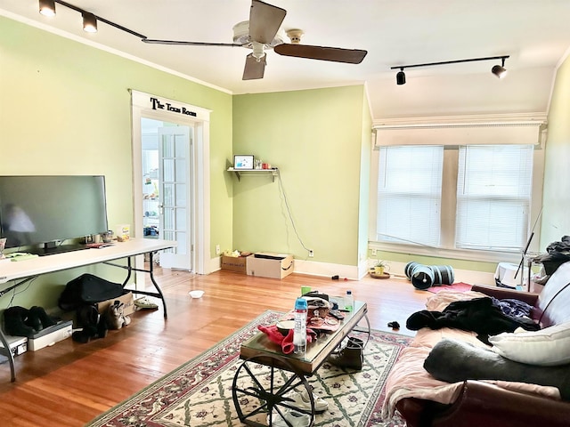 living room featuring ceiling fan, light hardwood / wood-style flooring, track lighting, and ornamental molding