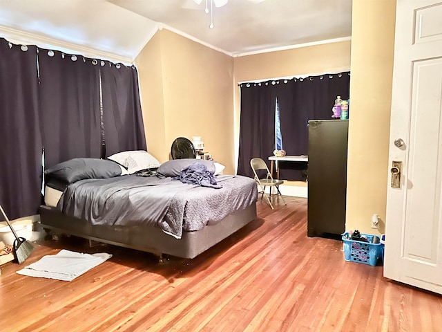 bedroom featuring hardwood / wood-style floors and crown molding