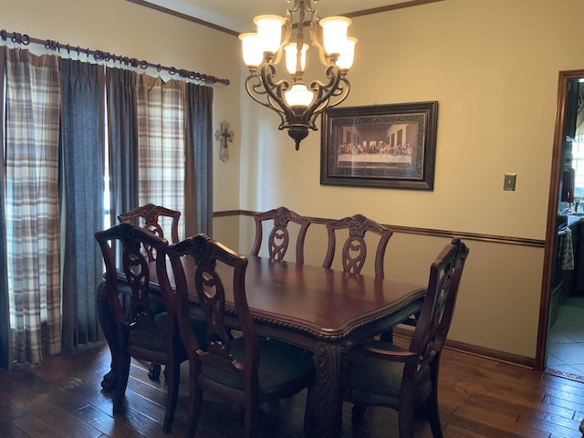 dining area featuring an inviting chandelier, a wealth of natural light, and dark wood-type flooring