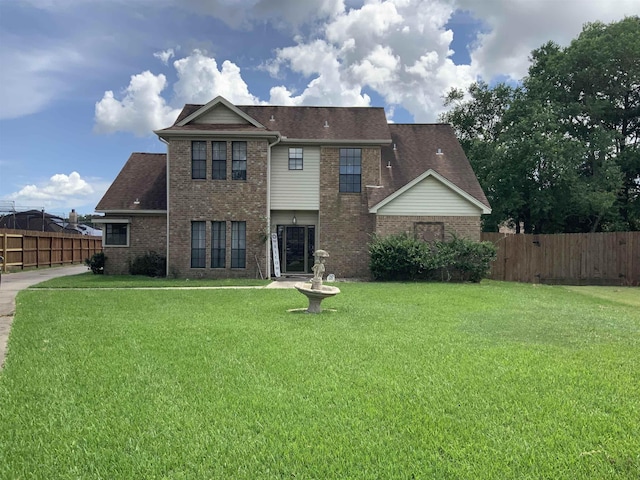 rear view of house with a yard