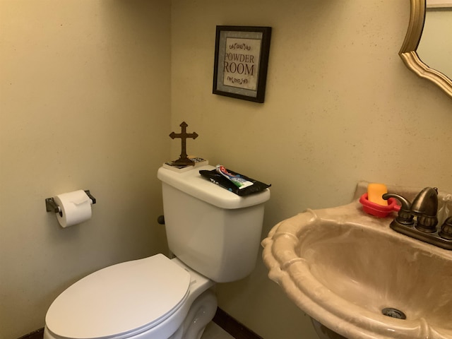 bathroom featuring toilet and sink