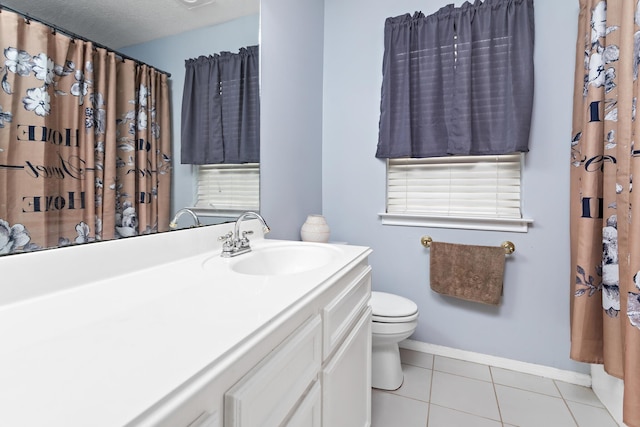 7845 Indian Blanket Dr, Beaumont, TX 77713 - bathroom featuring toilet, tile patterned floors, baseboards, and vanity