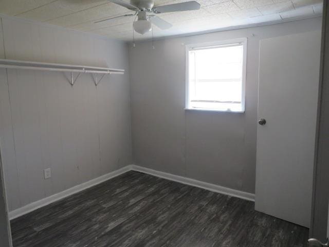 spare room featuring dark hardwood / wood-style flooring and ceiling fan