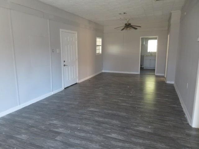 spare room featuring dark hardwood / wood-style flooring and ceiling fan