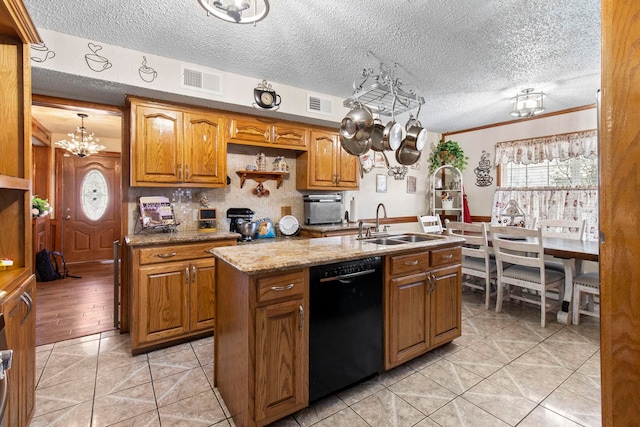 kitchen with light tile patterned floors, a sink, black dishwasher, light stone countertops, and brown cabinetry