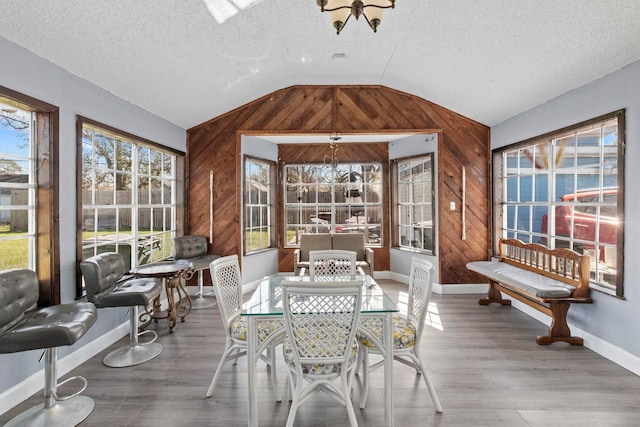 sunroom / solarium featuring vaulted ceiling