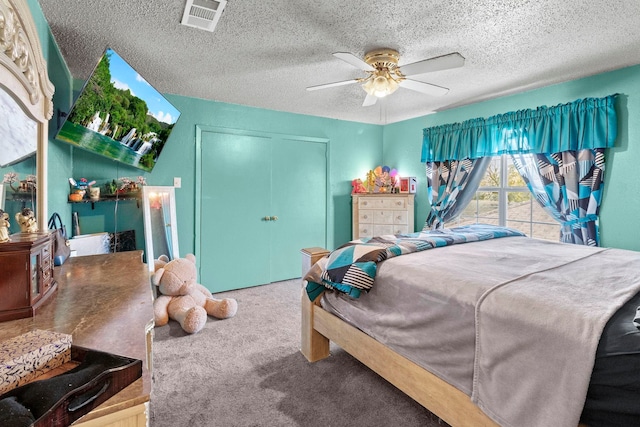 bedroom featuring a closet, visible vents, carpet flooring, ceiling fan, and a textured ceiling