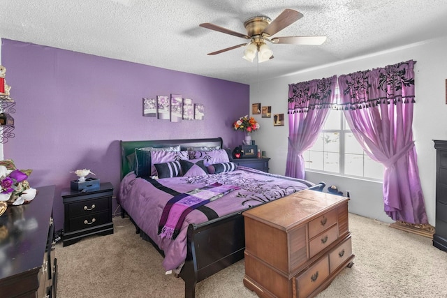 bedroom featuring light carpet, ceiling fan, and a textured ceiling