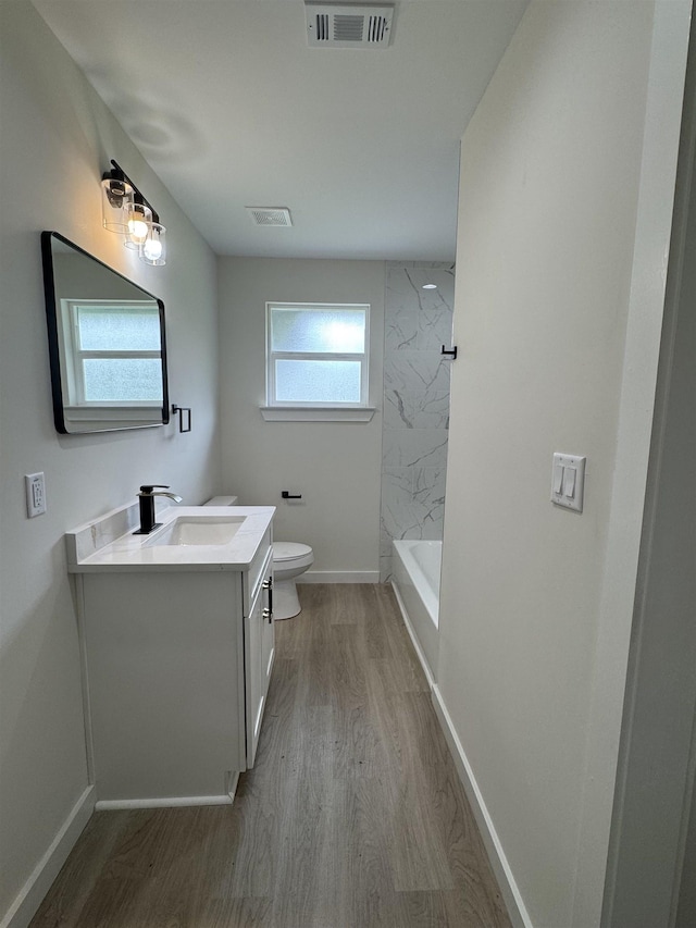 3022 S Drive, Groves, TX 77619 - bathroom featuring vanity and wood finished floors