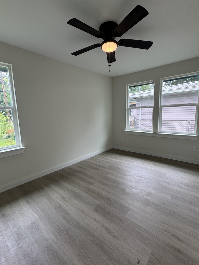 3022 S Drive, Groves, TX 77619 - empty room featuring wood finished floors and a ceiling fan