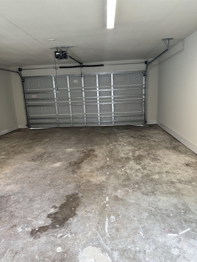 3022 S Drive, Groves, TX 77619 - garage with baseboards and a garage door opener