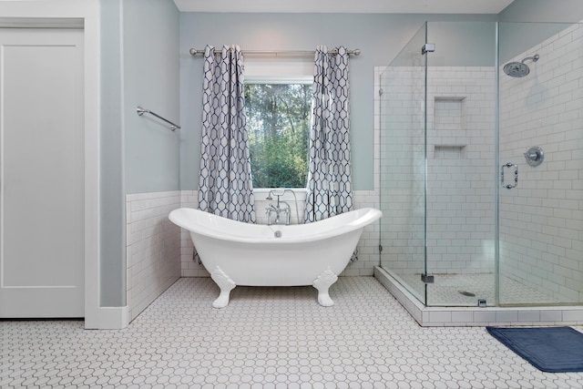 bathroom with separate shower and tub and tile walls